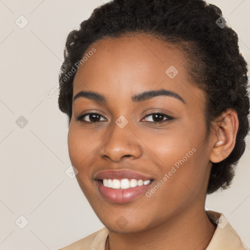 Joyful black young-adult female with short  brown hair and brown eyes