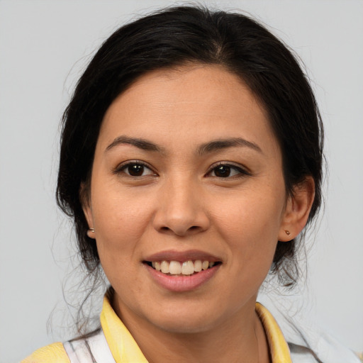 Joyful asian young-adult female with medium  brown hair and brown eyes