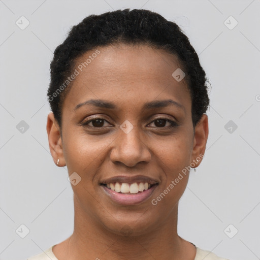 Joyful black young-adult female with short  black hair and brown eyes