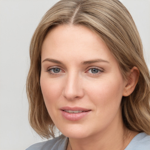 Joyful white young-adult female with medium  brown hair and blue eyes