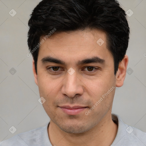 Joyful white young-adult male with short  black hair and brown eyes