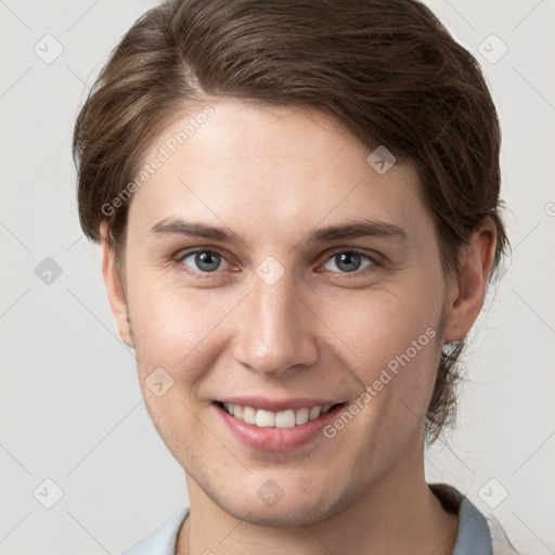 Joyful white young-adult female with short  brown hair and grey eyes