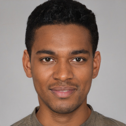 Joyful black young-adult male with short  black hair and brown eyes