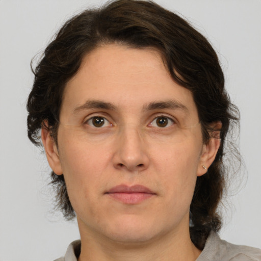 Joyful white adult male with medium  brown hair and brown eyes