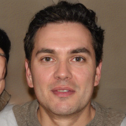 Joyful white young-adult male with short  black hair and brown eyes