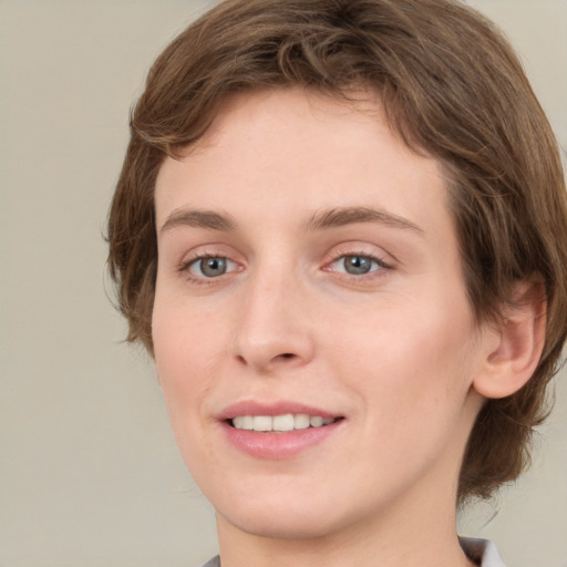 Joyful white young-adult female with medium  brown hair and green eyes