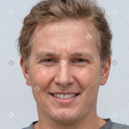 Joyful white adult male with short  brown hair and grey eyes