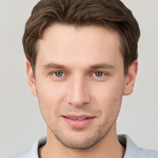 Joyful white young-adult male with short  brown hair and brown eyes