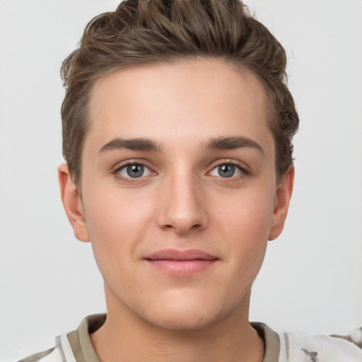 Joyful white young-adult female with short  brown hair and grey eyes