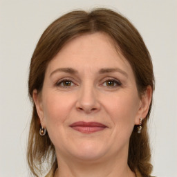 Joyful white adult female with medium  brown hair and grey eyes