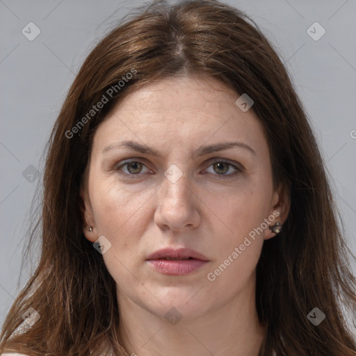 Joyful white adult female with long  brown hair and grey eyes