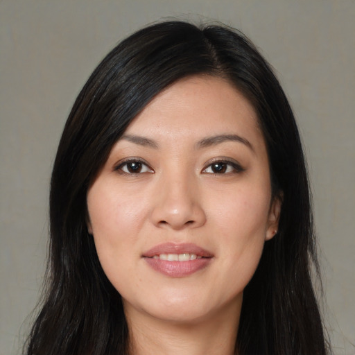 Joyful white young-adult female with long  black hair and brown eyes