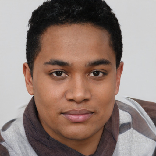 Joyful black young-adult male with short  black hair and brown eyes