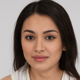 Joyful latino young-adult female with medium  brown hair and brown eyes