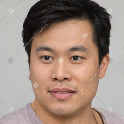 Joyful asian young-adult male with short  brown hair and brown eyes