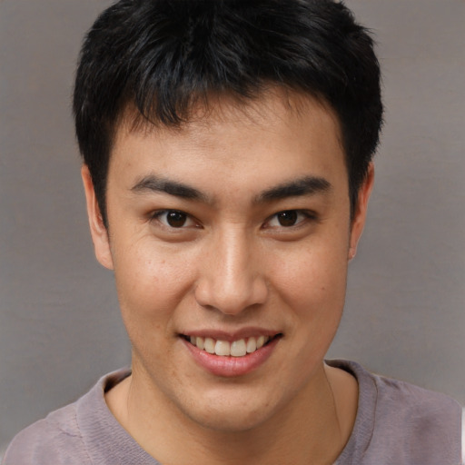 Joyful asian young-adult male with short  brown hair and brown eyes