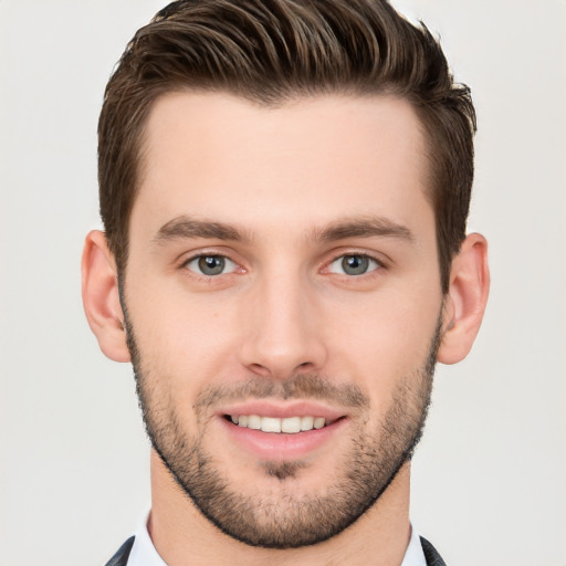 Joyful white young-adult male with short  brown hair and brown eyes