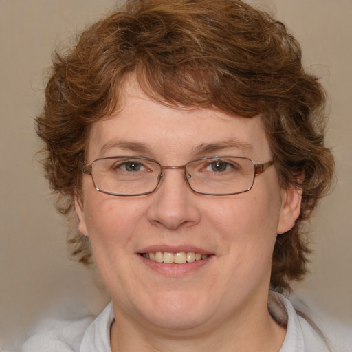 Joyful white adult female with medium  brown hair and blue eyes