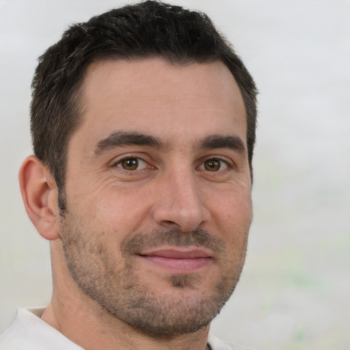 Joyful white adult male with short  brown hair and brown eyes