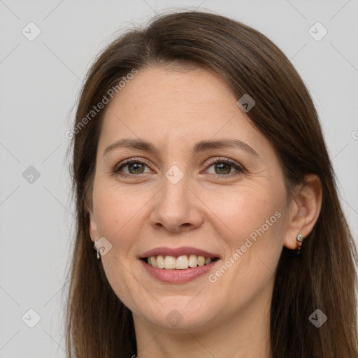 Joyful white adult female with long  brown hair and grey eyes