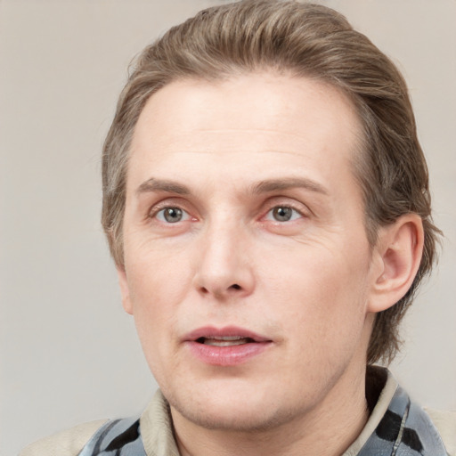 Joyful white adult male with short  brown hair and grey eyes