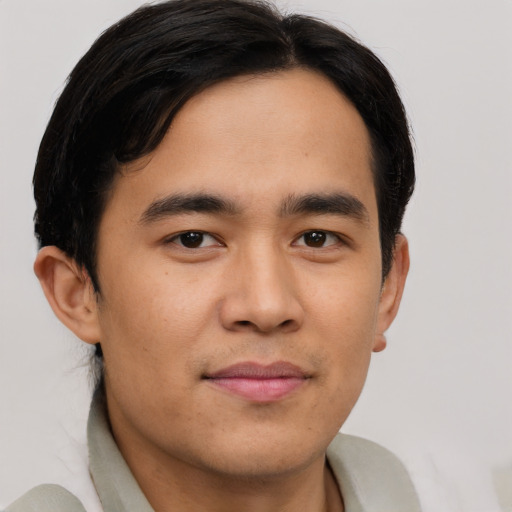 Joyful latino young-adult male with short  brown hair and brown eyes