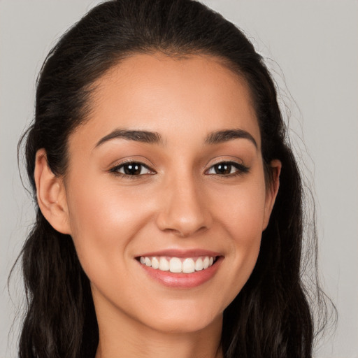 Joyful white young-adult female with long  brown hair and brown eyes