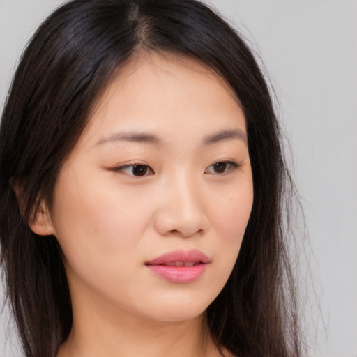 Joyful asian young-adult female with long  brown hair and brown eyes