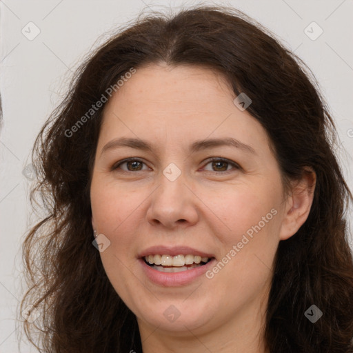 Joyful white adult female with long  brown hair and brown eyes