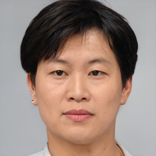 Joyful asian adult male with short  brown hair and brown eyes