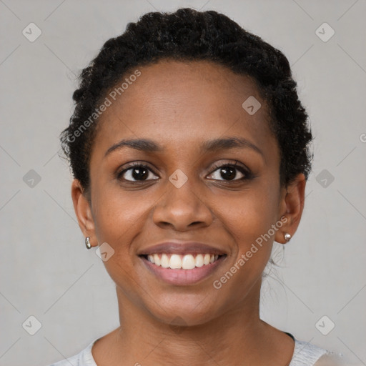 Joyful black young-adult female with short  black hair and brown eyes