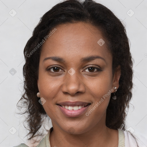 Joyful black young-adult female with long  brown hair and brown eyes