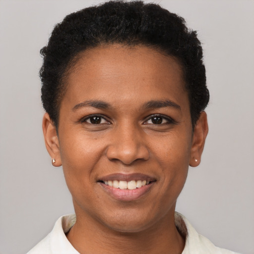 Joyful black young-adult female with short  black hair and brown eyes