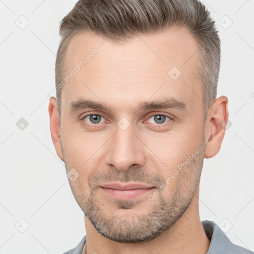 Joyful white adult male with short  brown hair and brown eyes