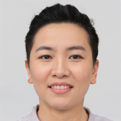 Joyful asian young-adult female with short  black hair and brown eyes