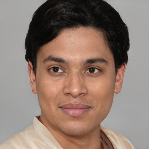 Joyful latino young-adult male with short  black hair and brown eyes