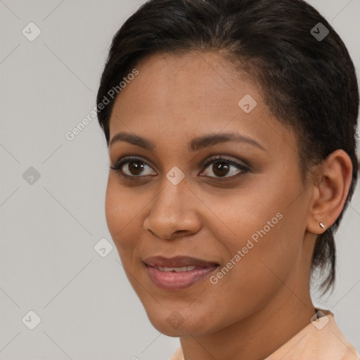 Joyful black young-adult female with short  brown hair and brown eyes