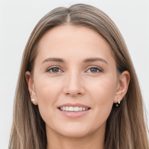 Joyful white young-adult female with long  brown hair and grey eyes