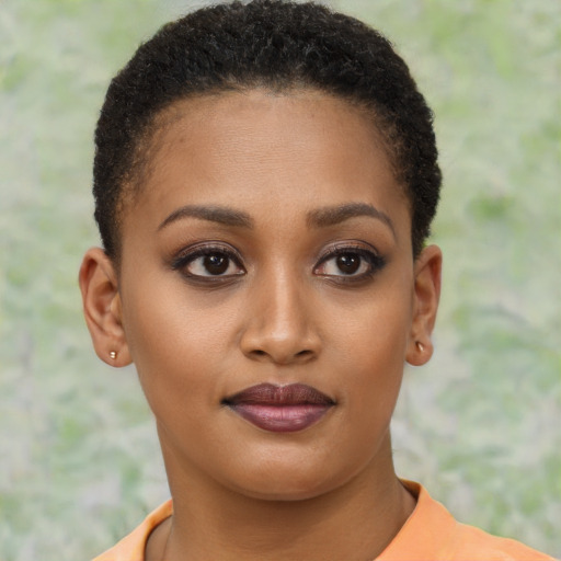 Joyful black young-adult female with short  brown hair and brown eyes