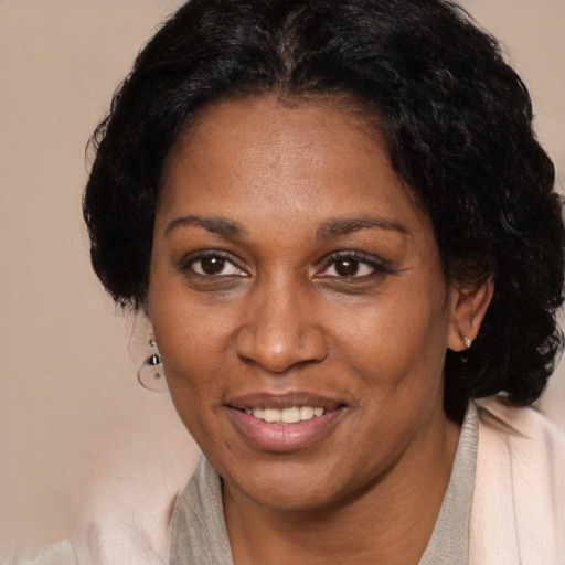 Joyful black adult female with short  brown hair and brown eyes