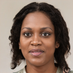 Joyful black young-adult female with medium  brown hair and brown eyes