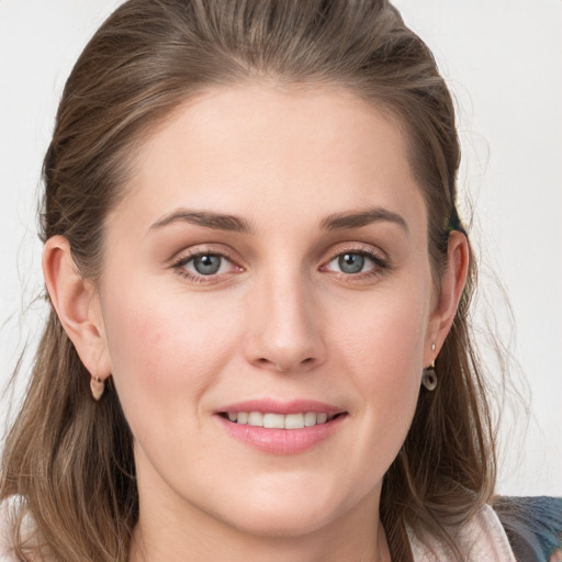 Joyful white young-adult female with medium  brown hair and grey eyes