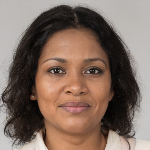 Joyful black adult female with medium  brown hair and brown eyes