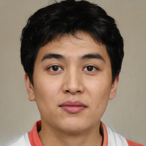 Joyful asian young-adult male with short  black hair and brown eyes