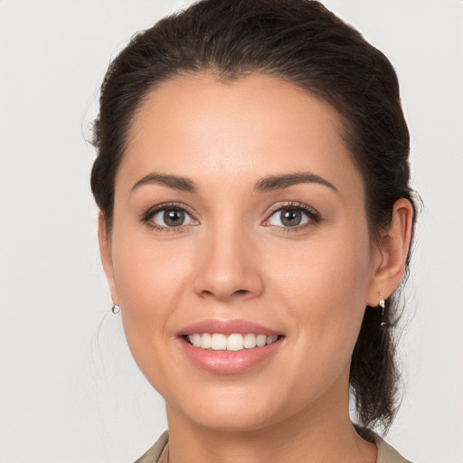 Joyful white young-adult female with medium  brown hair and brown eyes