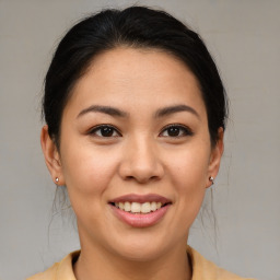 Joyful asian young-adult female with medium  brown hair and brown eyes