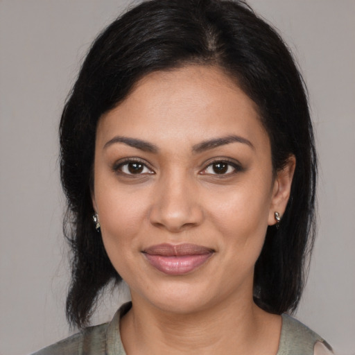 Joyful latino young-adult female with medium  black hair and brown eyes