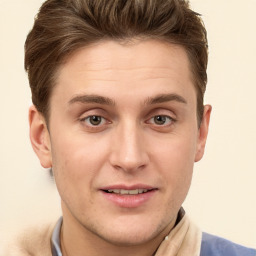 Joyful white young-adult male with short  brown hair and grey eyes