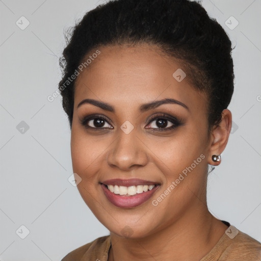 Joyful black young-adult female with short  brown hair and brown eyes