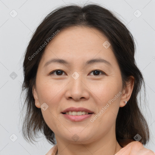 Joyful white adult female with medium  brown hair and brown eyes